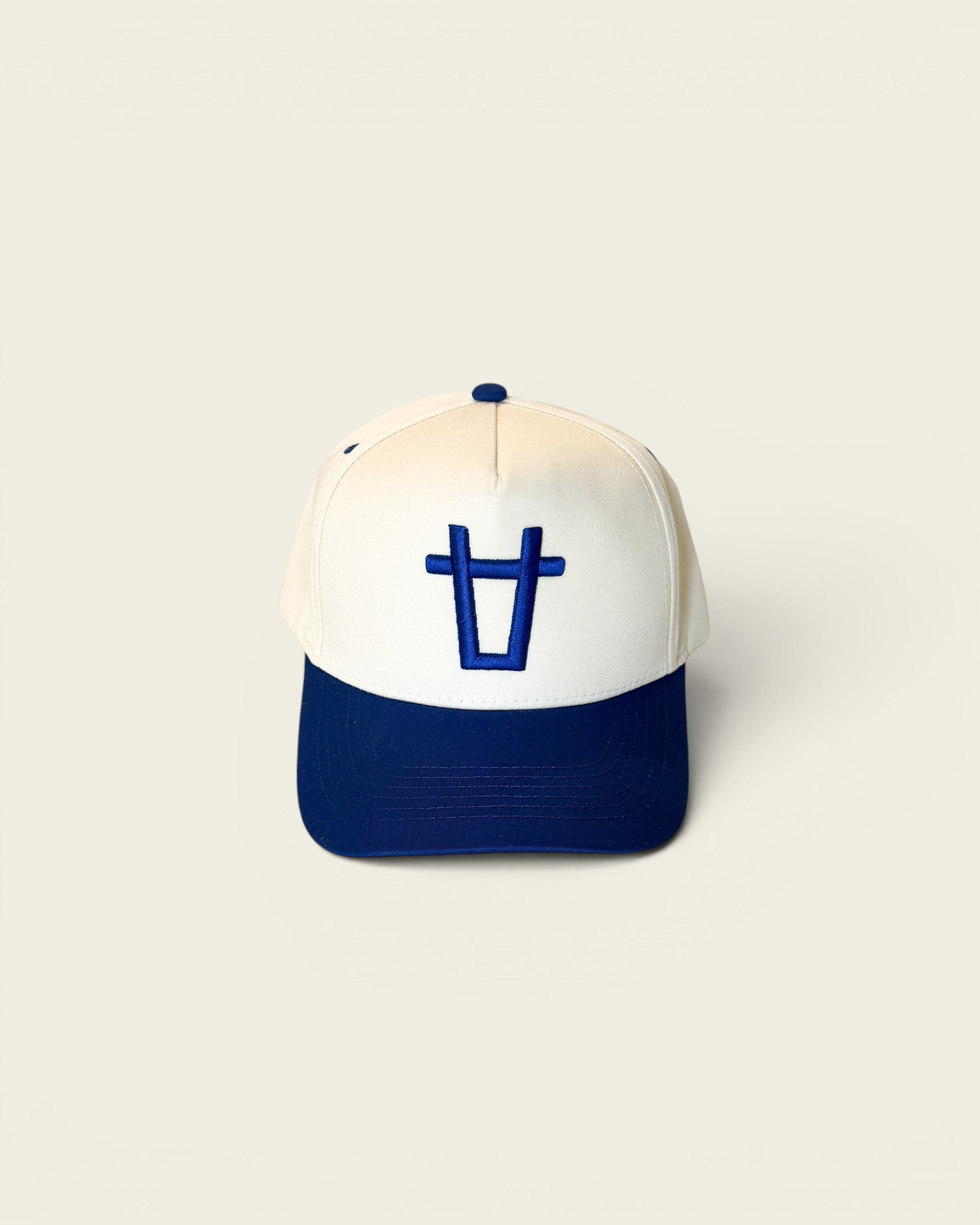 Ayredale Ranch & Co white baseball cap with blue brim and embroidered blue bull head logo on front.