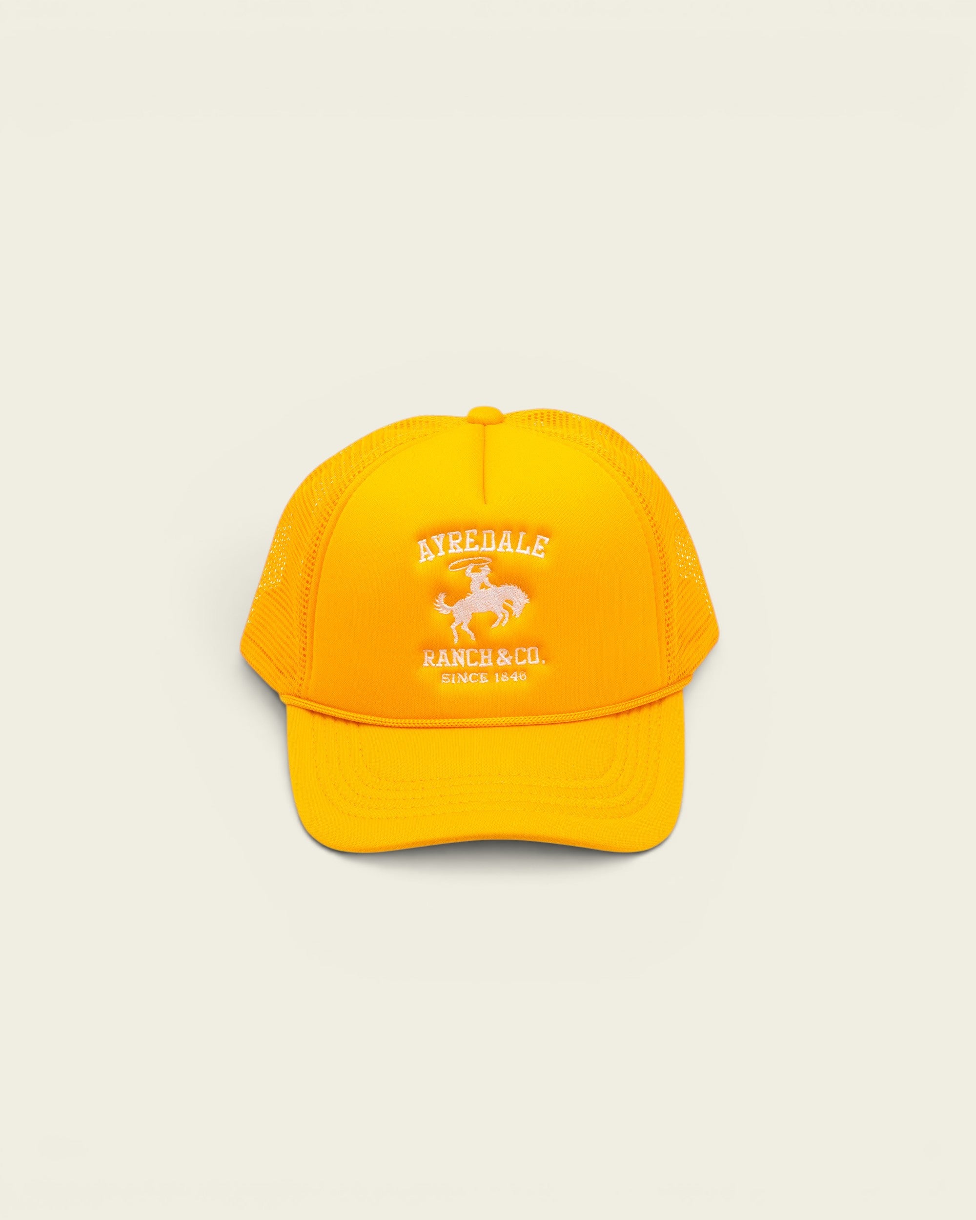 Ayredale Ranch & Co yellow trucker hat with white embroidered cowboy logo and mesh back panel