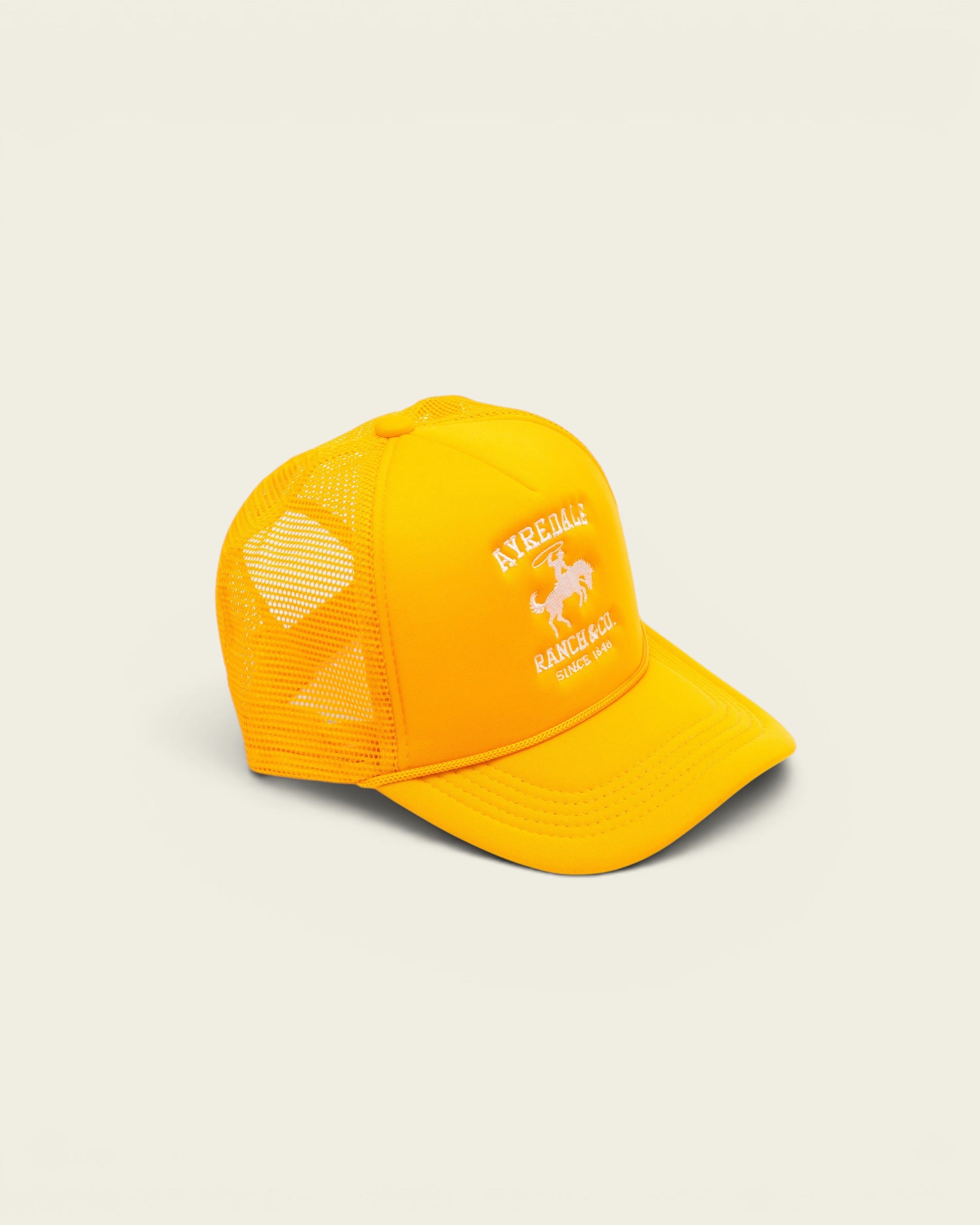 Ayredale Ranch & Co yellow trucker hat with white cowboy logo embroidery and breathable mesh back panel